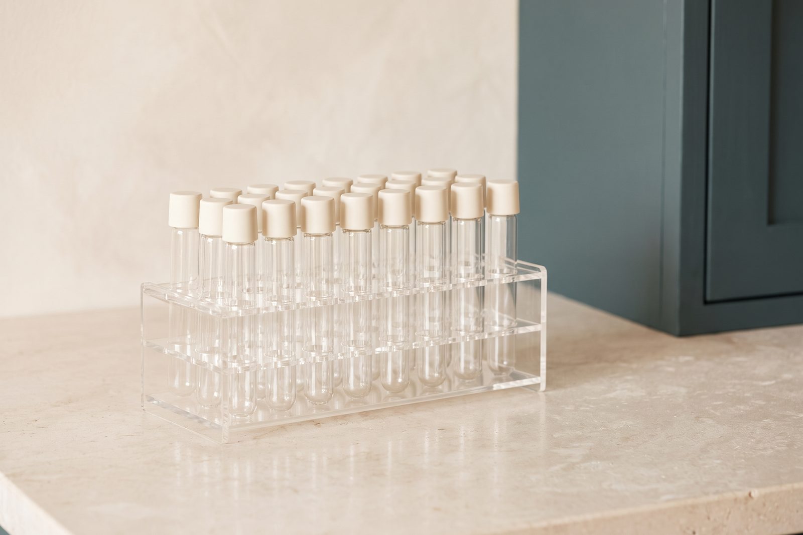 Rack of laboratory sample tubes arranged on a pale stone counter